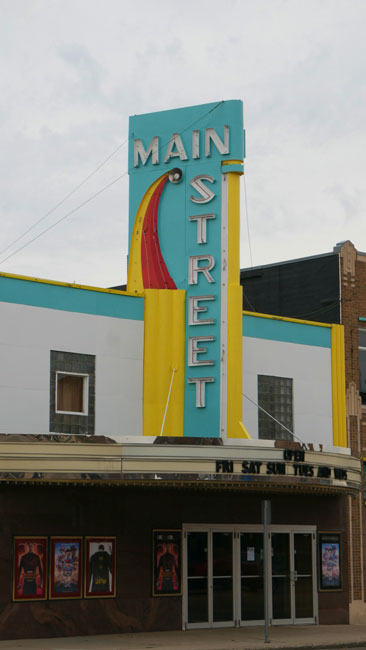 Looking at the exterior and marquee of the Main Street Theatre from the North across Main Street in Sauk Centre, MN on an overcast day.