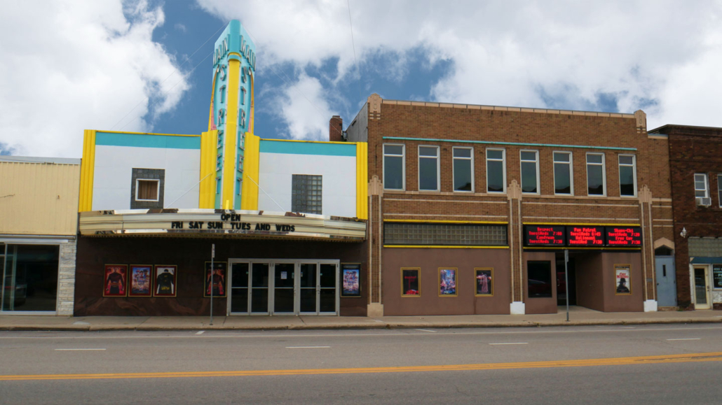 Looking at the exterior and marquee of the Main Street Theatre from the West across Main Street in Sauk Centre, MN on an overcast day.